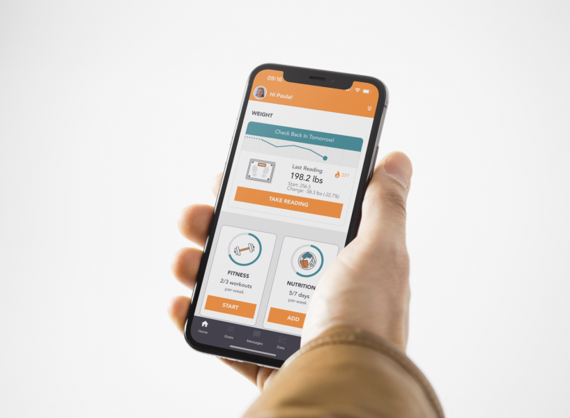 A patient holds their mobile phone and looks at their PACE Patient dashboard